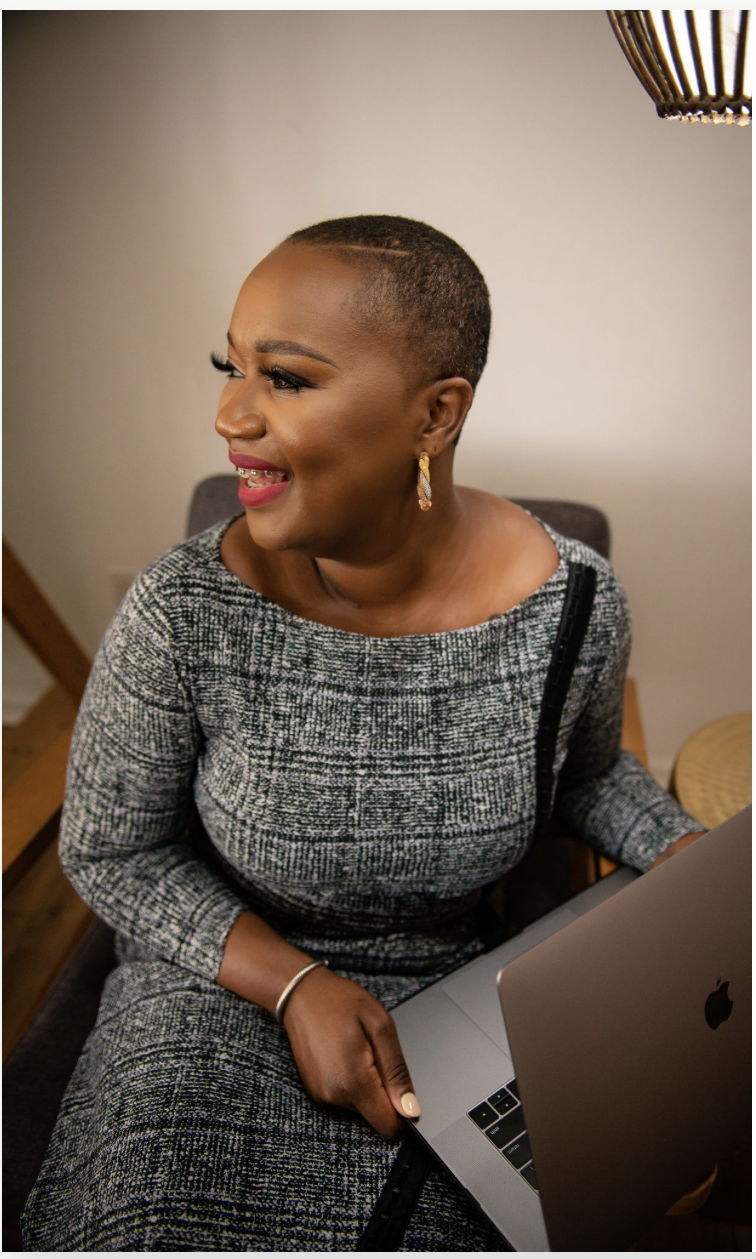 Black lawyer woman sitting with a laptop looking outside